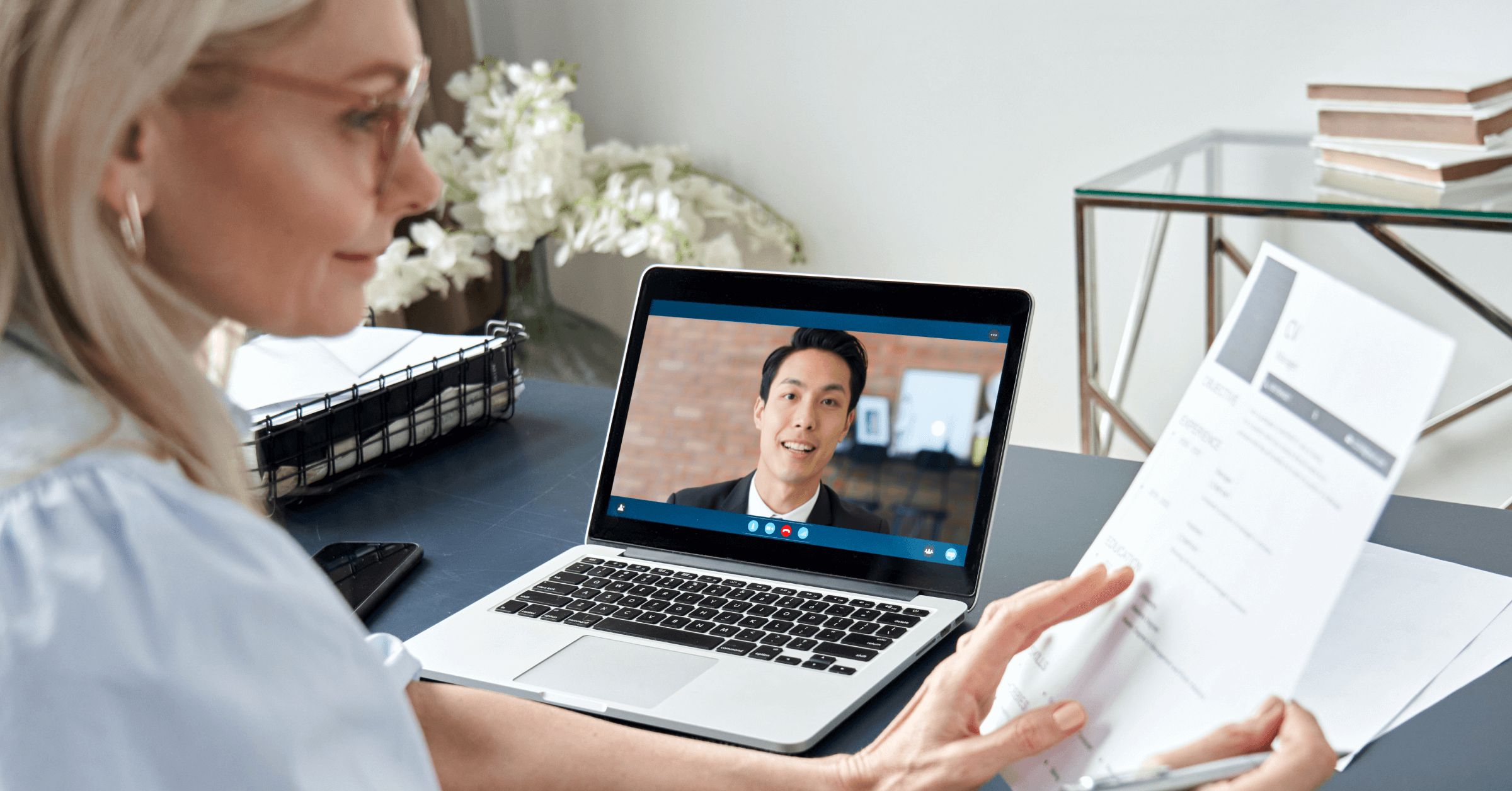 A woman conducting a virtual interview with a residency applicant. 