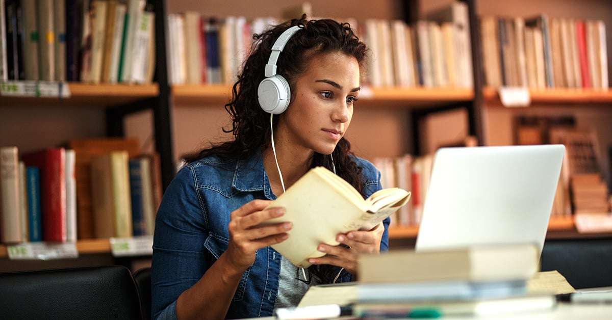 A young woman studies in a library as she prepares for the upcoming USMLE Step 1 exam dates in 2023. 